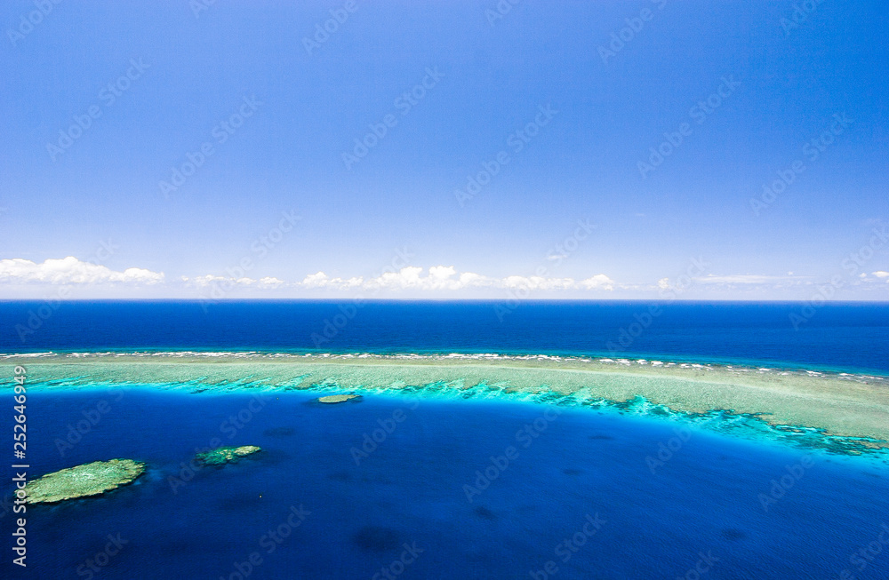 aerial view of great barrier reef with coral reef, sea and blue sky