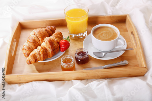 breakfast tray in bed : coffee, croissants and juice