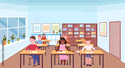 mix race pupils sitting desks and doing tasks during lesson education concept modern school classroom interior horizontal flat
