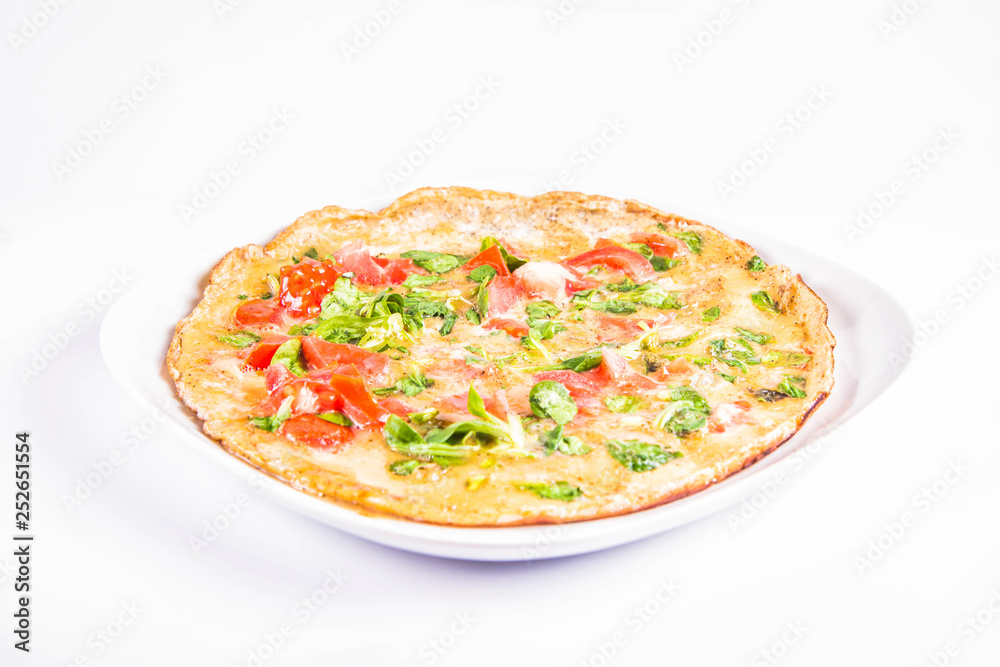 Omelette with tomatoes and fresh corn salad on a white background