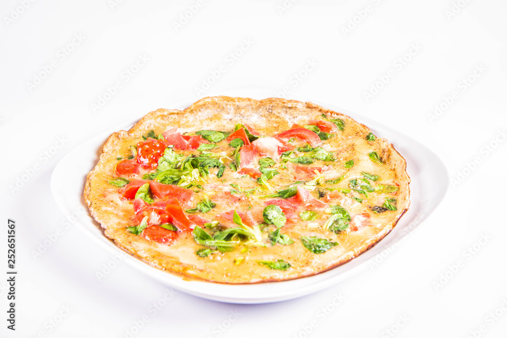 Omelette with tomatoes and fresh corn salad on a white background Omelette with tomatoes and fresh corn salad on a white background