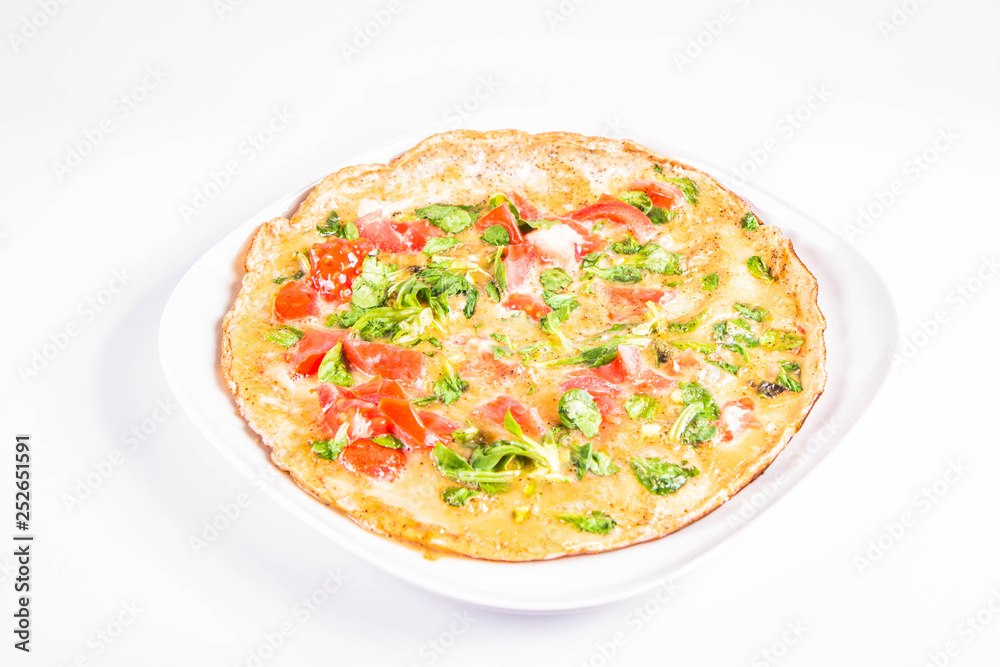 Omelette with tomatoes and fresh corn salad on a white background
