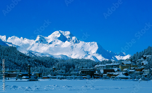 Swiss alps  View from frozen Lake St. Moritz to the bright shining Piz Maloja in the Upper Engadin