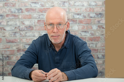 portrait of senior man with beard and glasses