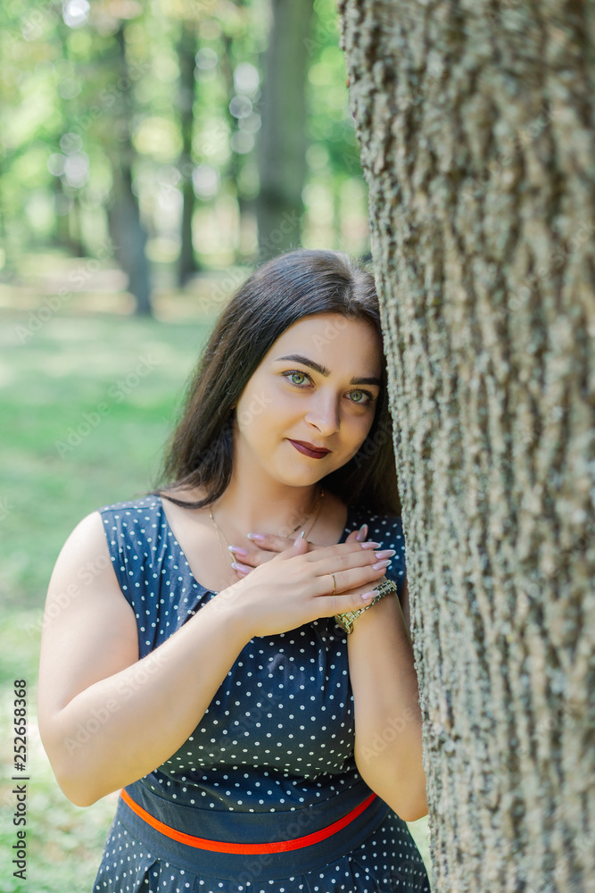 Plus size fashion model in casual clothes, overweight female body in a park outdoors. Plus size fashion model in casual clothes, overweight female body in a park outdoors.