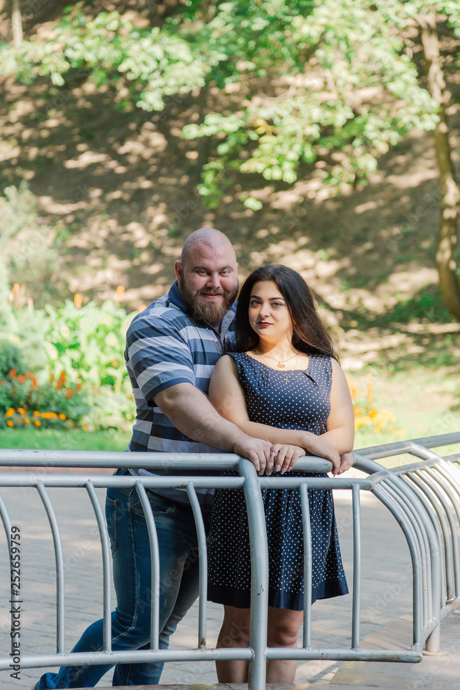 Two people in love are standing at the idle fountain in the park. Two people in love are standing at the idle fountain in the park.