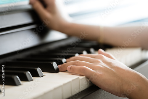 Child Hand playing Music keyboard electric piano photo