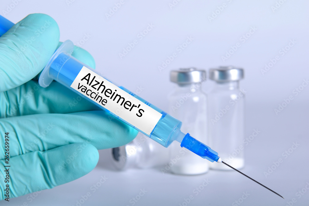 Vaccination healthcare concept. Hands of doctor or nurse in medical gloves with medical syringe ready for injection a shot of Alzheimer's vaccine. close up, selective focus - Image Vaccination healthcare concept. Hands of doctor or nurse in medical gloves with medical syringe ready for injection a shot of Alzheimer's vaccine. close up, selective focus - Image