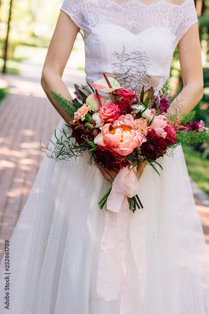 bright wedding bouquet in the hands of the bride bright wedding bouquet in the hands of the bride