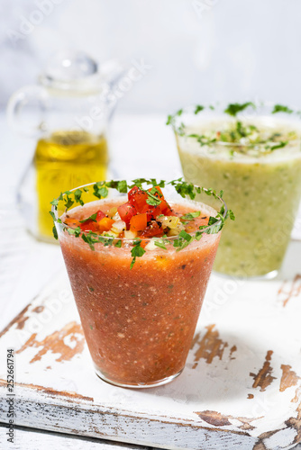 fresh cold soups. red and green gazpacho in glasses, vertical