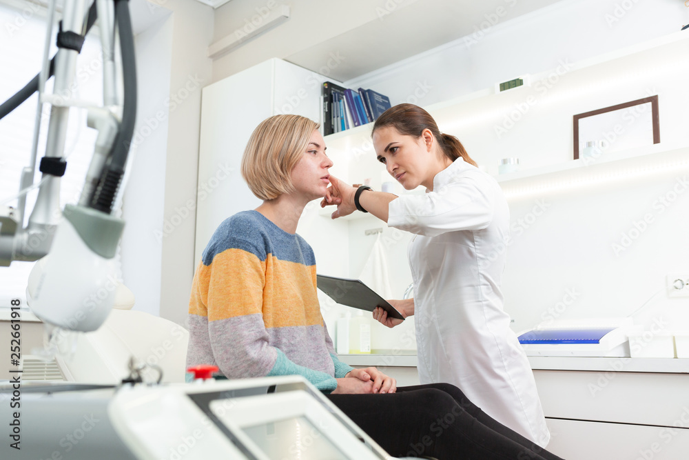 Obraz premium Professional woman cosmetologist in beauty clinic consulting young female client. Skin Care concept