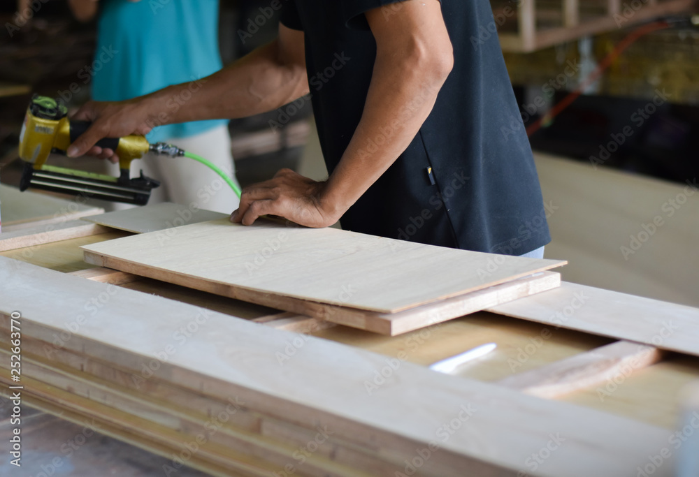 Hand of carpenter working with furniture wood. Hand of carpenter working with furniture wood.