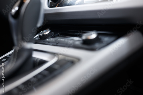 Car interior. Modern car illuminated dashboard. Luxurious car instrument cluster. Close up shot of automobile instrument panel. Modern car interior dashboard and steering wheel © svetlichniy_igor