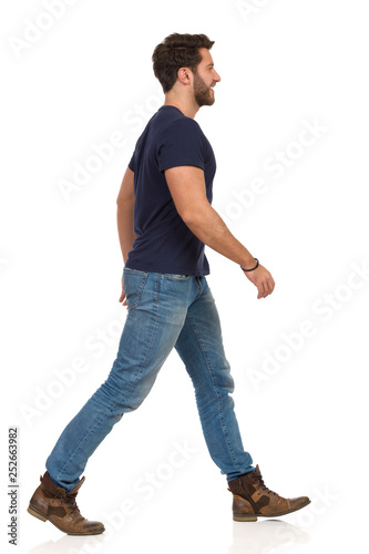Happy Walking Man In Blue T-shirt, Jeans And Boots