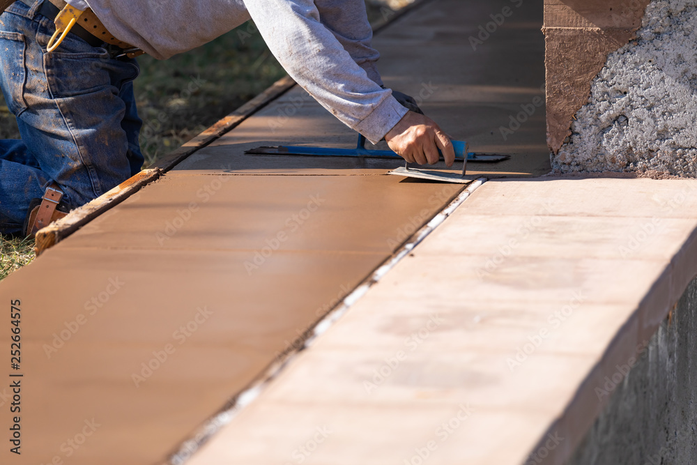 Construction Worker Smoothing Wet Cement With Hand Edger Tool Construction Worker Smoothing Wet Cement With Hand Edger Tool
