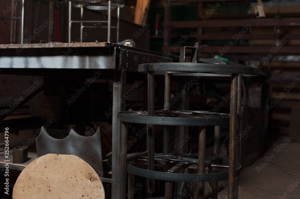 Row of metal chairs in blacksmith workshop