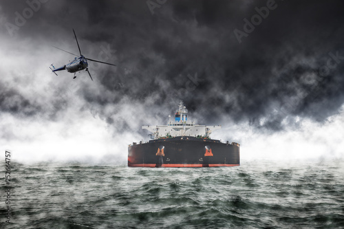 A helicopter rescue mission in difficult stormy weather at sea.