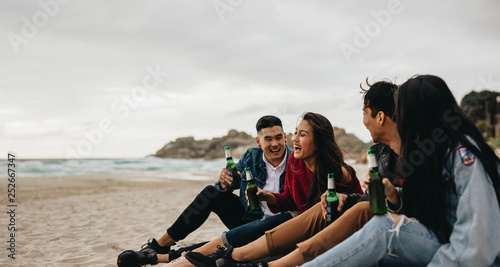 Four friends partying on the beach