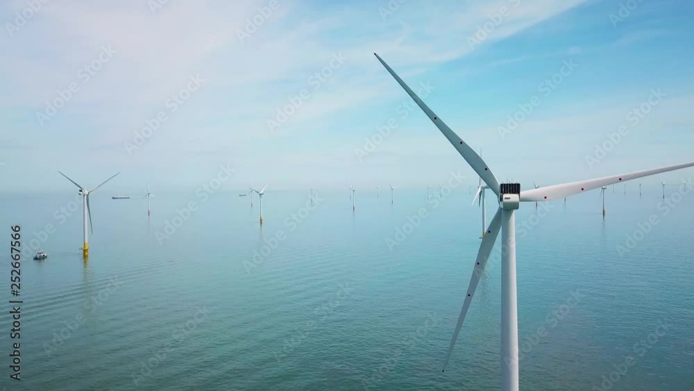 Remarkable drone aerial over windmills and turbines in the ocean off the coast of England.