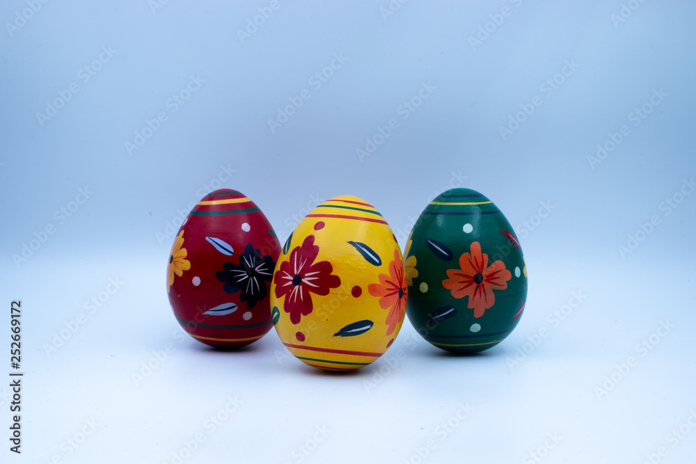 Colorful wooden easter eggs and chocolate with a touch of spring