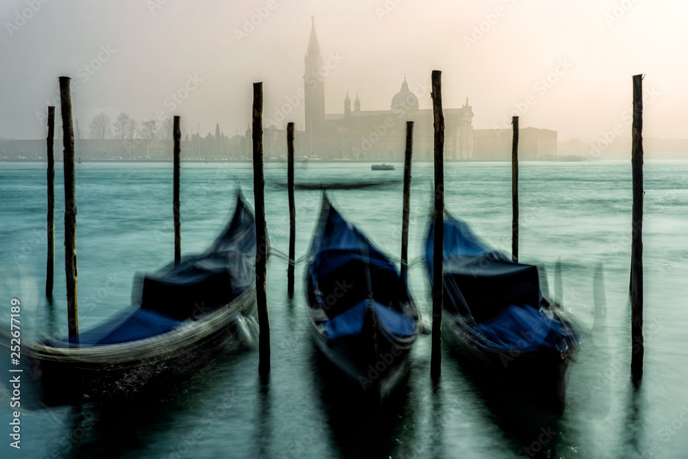 San Giorgio Maggiore church and gondolas in Venice during a misty/foggy spring day.