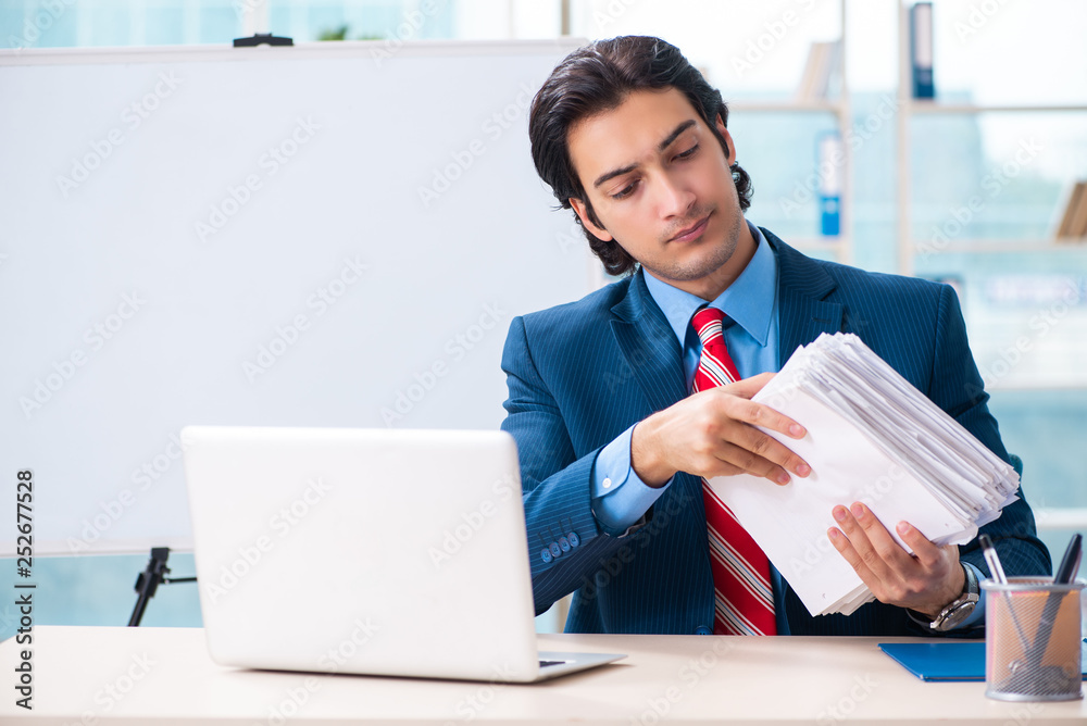 Young handsome businessman in front of whiteboard Young handsome businessman in front of whiteboard