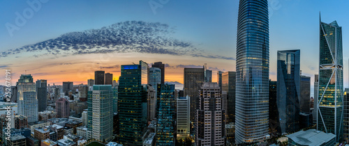 Photography Panorama with light spotted clouds in front of an orange glow of sunset looking