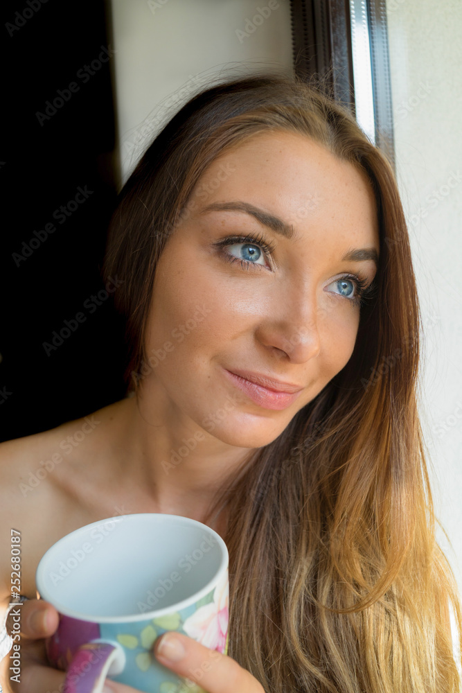 Portrait Of A Beautiful Woman With Blue Eyes Holding A Cup Portrait Of A Beautiful Woman With Blue Eyes Holding A Cup