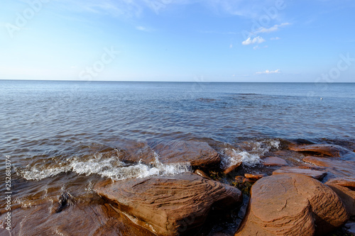 Rocks and small waves on the Saint Lawrence waterway on Prince Edward Island