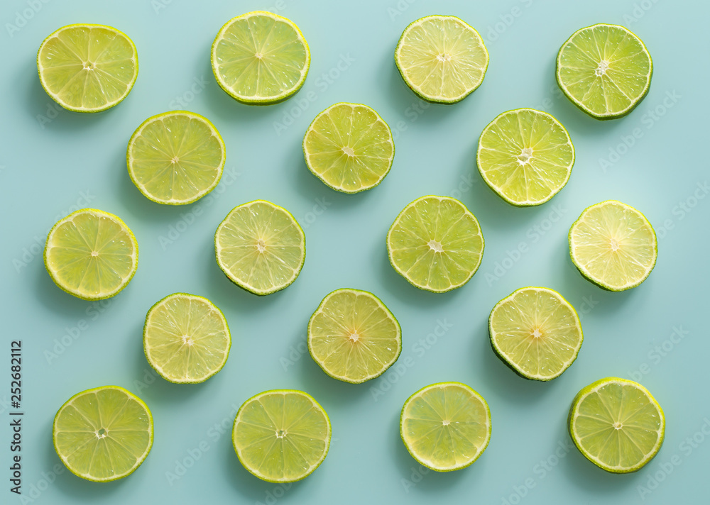 juicy slices of lime on the blue pastel glass background