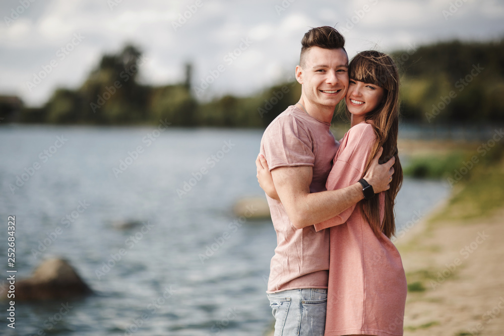 Loving young couple kissing and hugging in outdoors. Love and tenderness, dating, romance, family, anniversary concept.