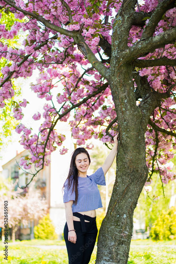 Plus size fashion model in casual clothes, overweight female body in a park outdoors. Spring concept. Plus size fashion model in casual clothes, overweight female body in a park outdoors. Spring concept.