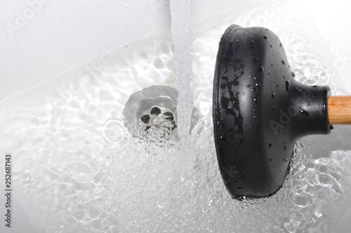 Photos Plunger and clogged sink.