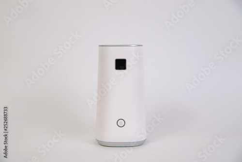 White air ionizer on a white, isolated background. The concept of taking care of the air in the apartment, taking care of the well-being. Air filter. photo