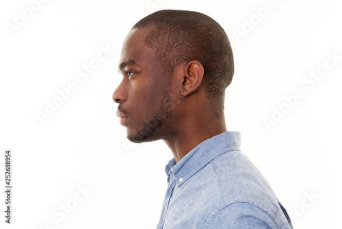 Close up profile of handsome young black man against isolated white background photo