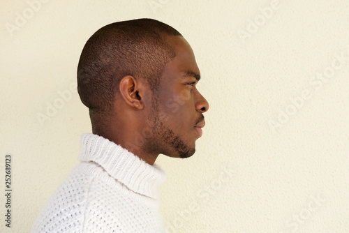 Close up profile of serious african american man in sweater