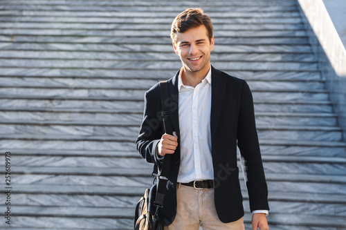 Handsome young business man carrying bag
