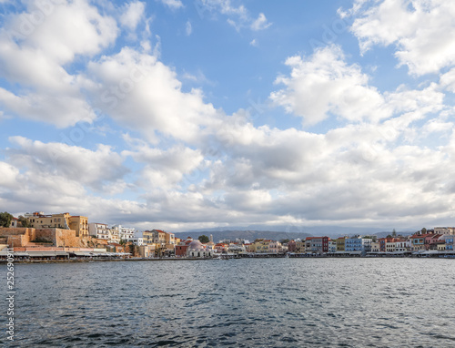 The city of Chania is a port on the west coast of the Cretan Sea in Greece. A tourist attraction, a long quay, interesting architecture, a Turkish bath building, houses. Mountains on the horizon.