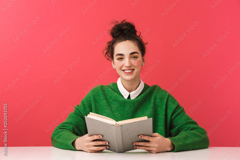 Pretty nerd girl sitting at the table isolated Pretty nerd girl sitting at the table isolated