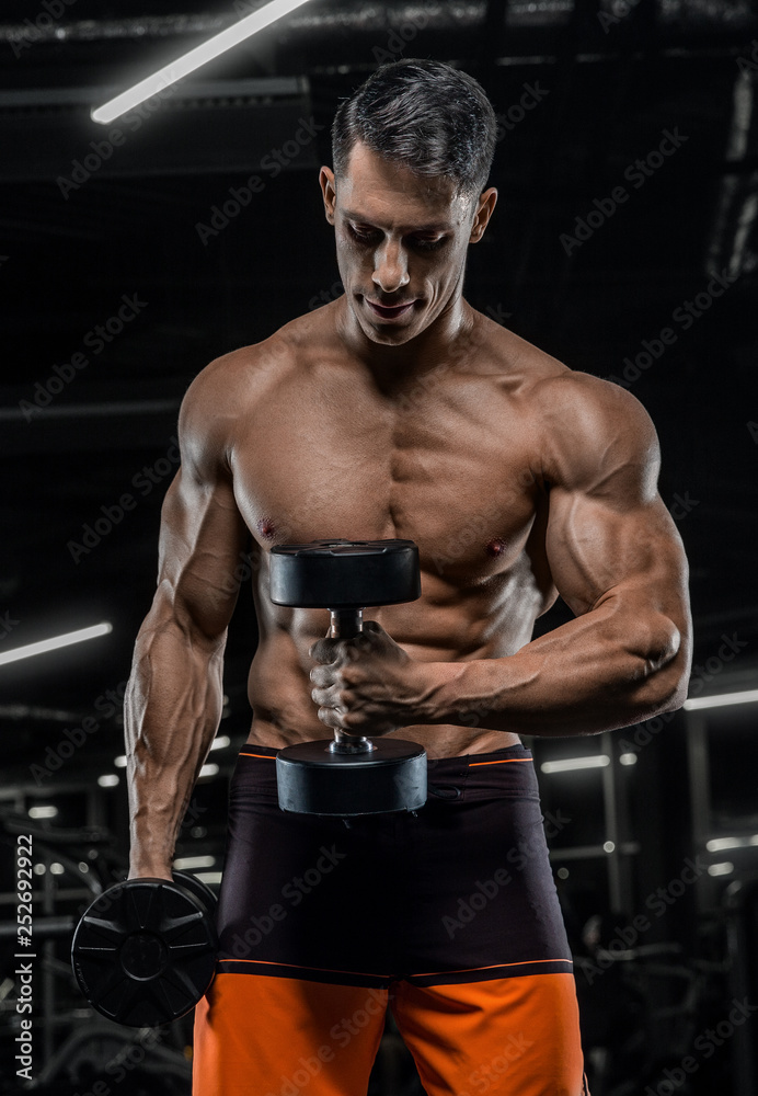 sexy strong bodybuilder athletic fitness man pumping up muscles workout  bodybuilding concept background - muscular bodybuilder handsome men doing  fitness exercises in gym naked torso foto de Stock | Adobe Stock