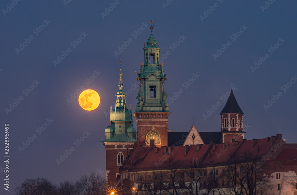 Fototapeta premium February Full Moon (Snow Moon, Supermoon) over Wawel castle and cathedral, Krakow, Poland