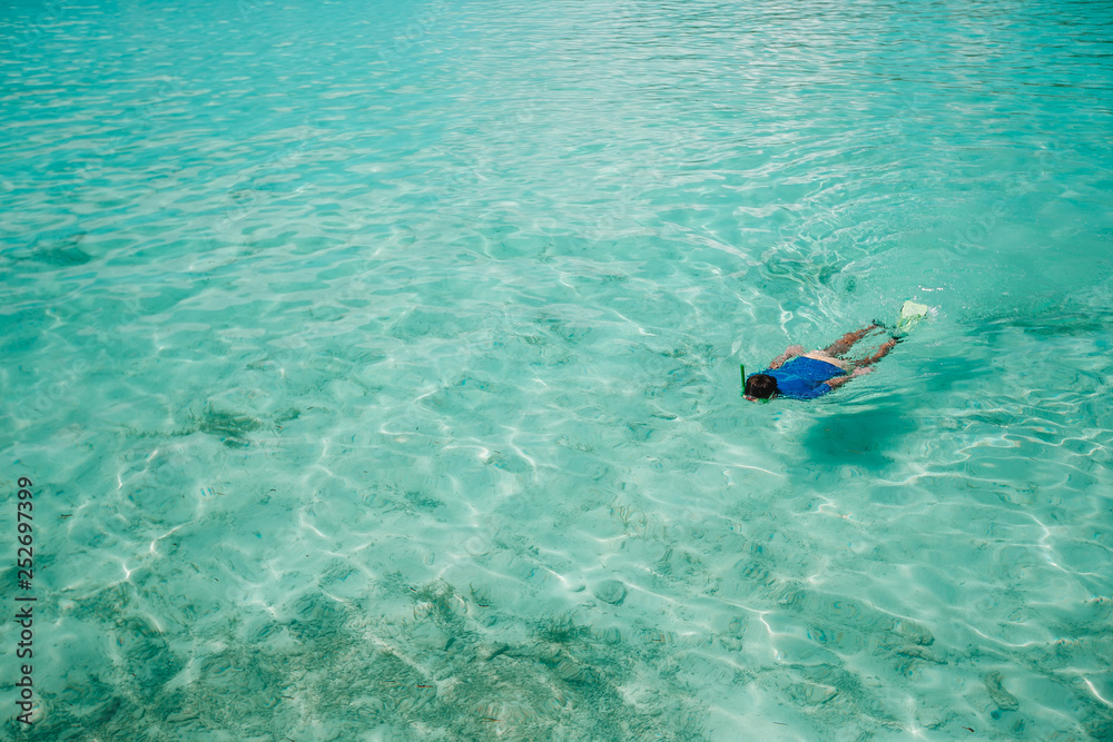 Man swimming in the amazingly turquoise ocean