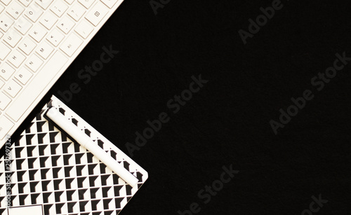 Black and white business backdrop: Keyboard and the notebook, selective focus, free copy space