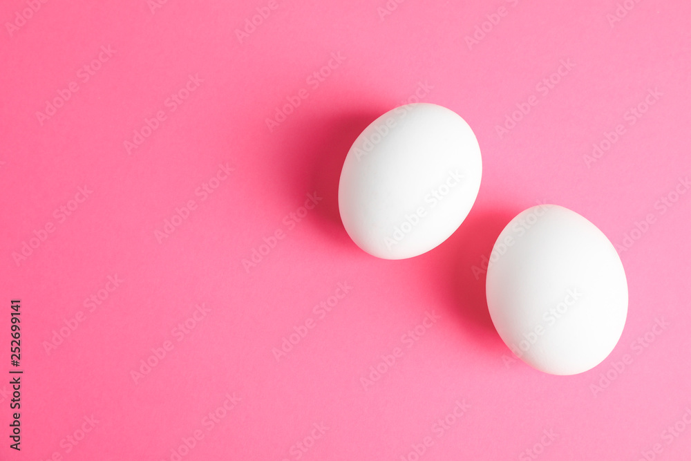 Chicken eggs on pink background, space for text Chicken eggs on pink background, space for text
