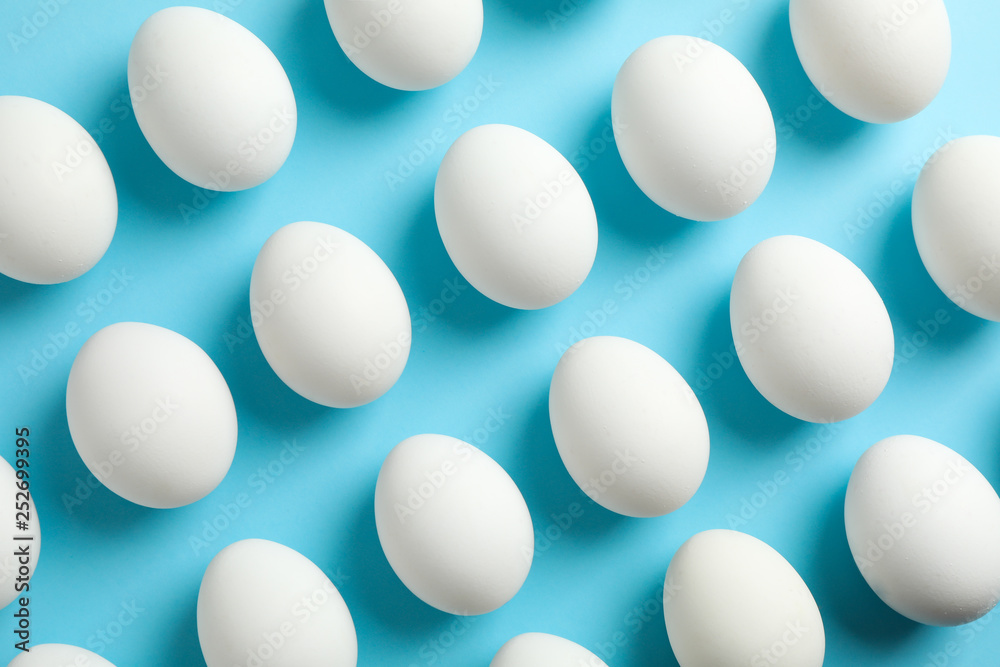 Flat lay composition with chicken eggs on color background, space for text