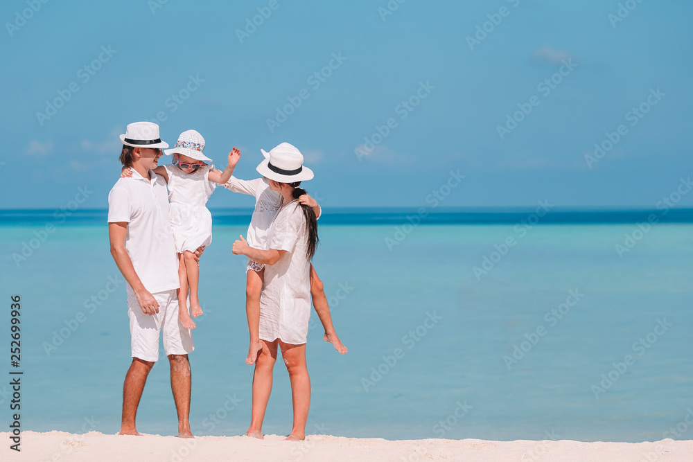 Family of four on beach vacation have fun Family of four on beach vacation have fun
