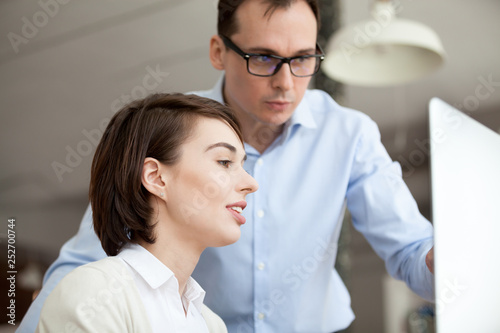 Businessman and businesswoman working together using computer
