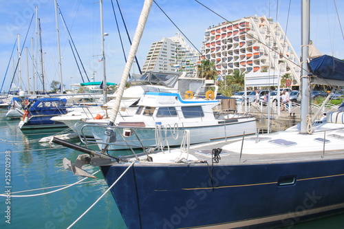 Pyramids buildings and pleasure boats in the seaside resort and marina of la Grande Motte in Herault department, France