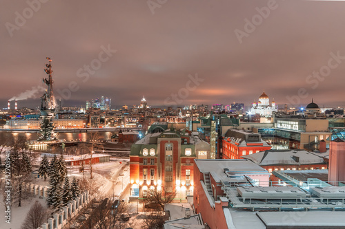 Aerial view to the iluminated city center of Moscow at night time. Monument to Peter the Great and Christ the Savior Cathedral