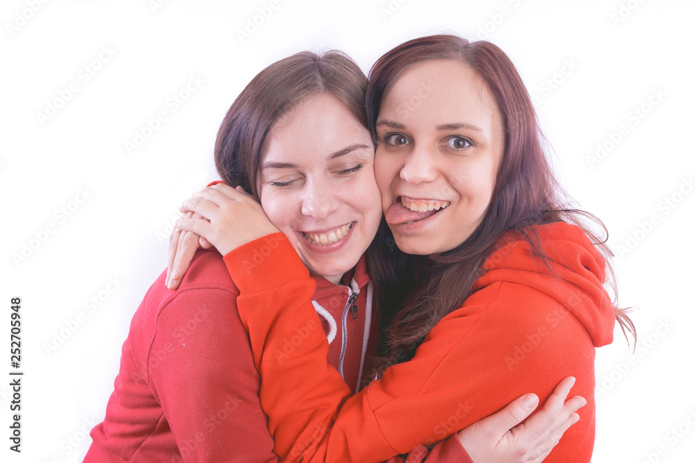 two friends or lesbians on a white background, smiling and laughing in the company of each other. The concept of female friendship and love two friends or lesbians on a white background, smiling and laughing in the company of each other. The concept of female friendship and love